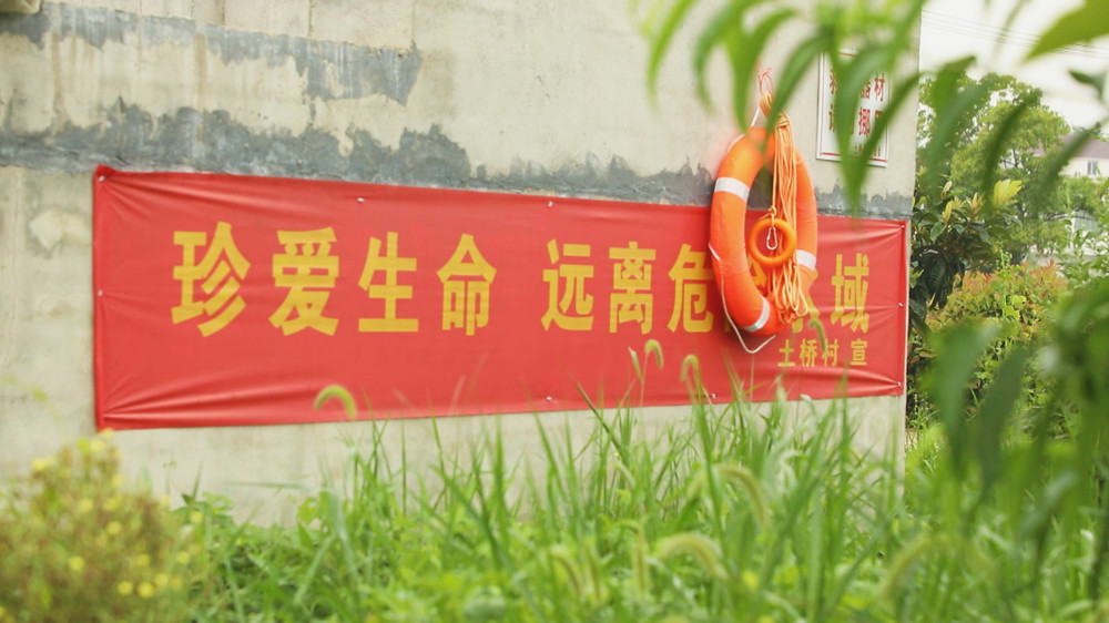 圖為土橋村設(shè)置的防溺水宣傳標(biāo)語和防溺水物資 .jpg
