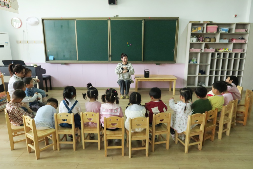 00后幼師洪香玲正帶著小朋友一起玩游戲.JPG