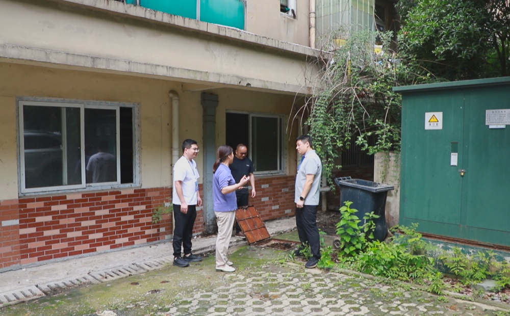 圖為龍騰街道錢莊社區(qū)工作人員正在和物業(yè)公司及業(yè)主共同查看污水管道堵塞情況。.jpg